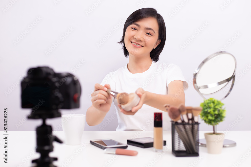 Beauty blogger is showing how to  make up while recording video