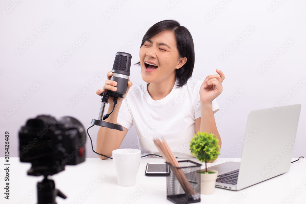 Woman blogger speaking in front of camera and recording video for social media Woman blogger speaking in front of camera and recording video for social media