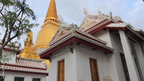 Camera pans to the top of a beautiful golden stupa in Buddhist temple in Bangkok, Thailand. (ID: 313426617)