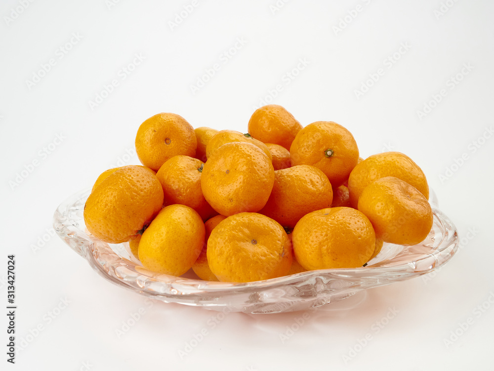 Tangerines or Mandarin orange fruit and peeled slices.On light background Tangerines or Mandarin orange fruit and peeled slices.On light background