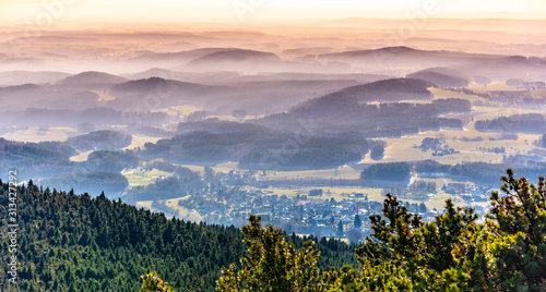 Hilly landscape in the mist under Jested Mountain. Weather temperature inversion, Czech Republic photo