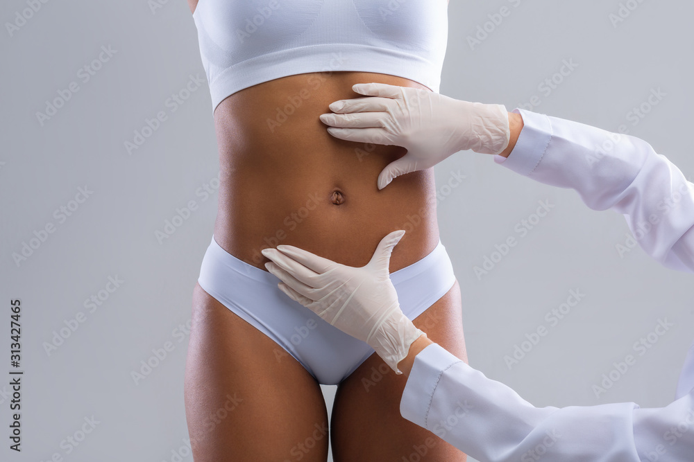 Plastic surgeon consulting woman before beauty procedure - obrazy, fototapety, plakaty 