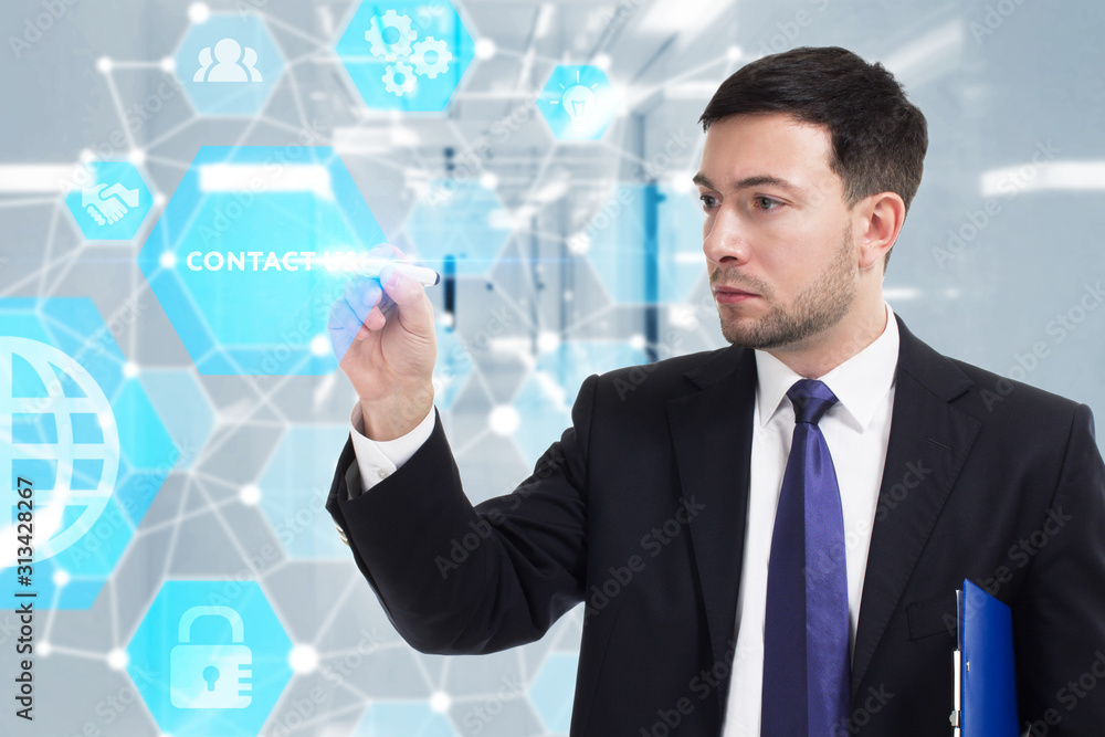 Business, Technology, Internet and network concept. Young businessman working on a virtual screen of the future and sees the inscription: Contact us Business, Technology, Internet and network concept. Young businessman working on a virtual screen of the future and sees the inscription: Contact us