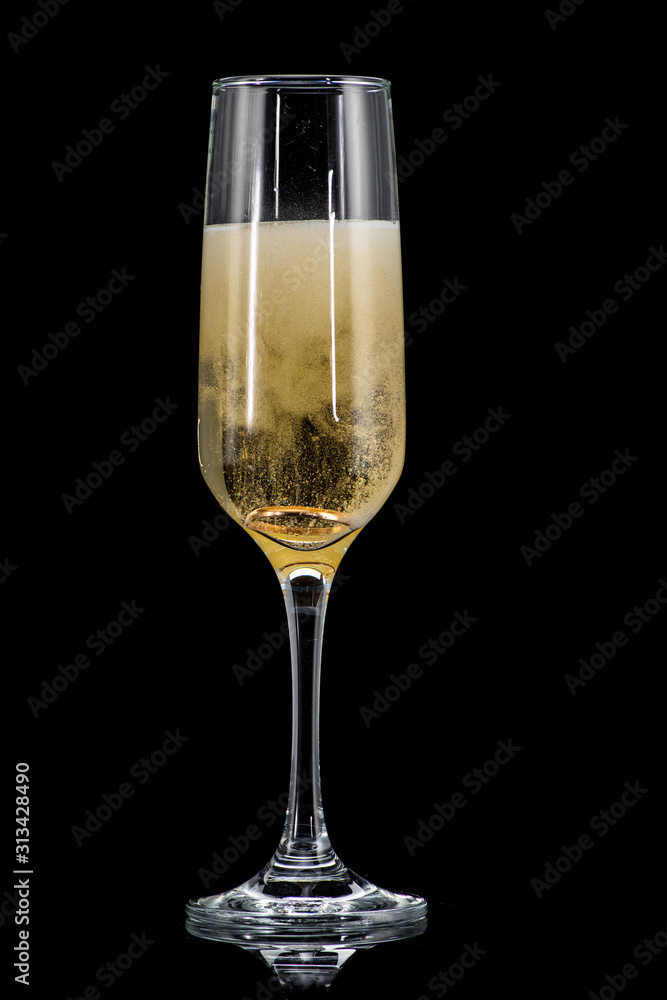 a golden ring in a glass with champagne, many bubbles, like a marriage proposal