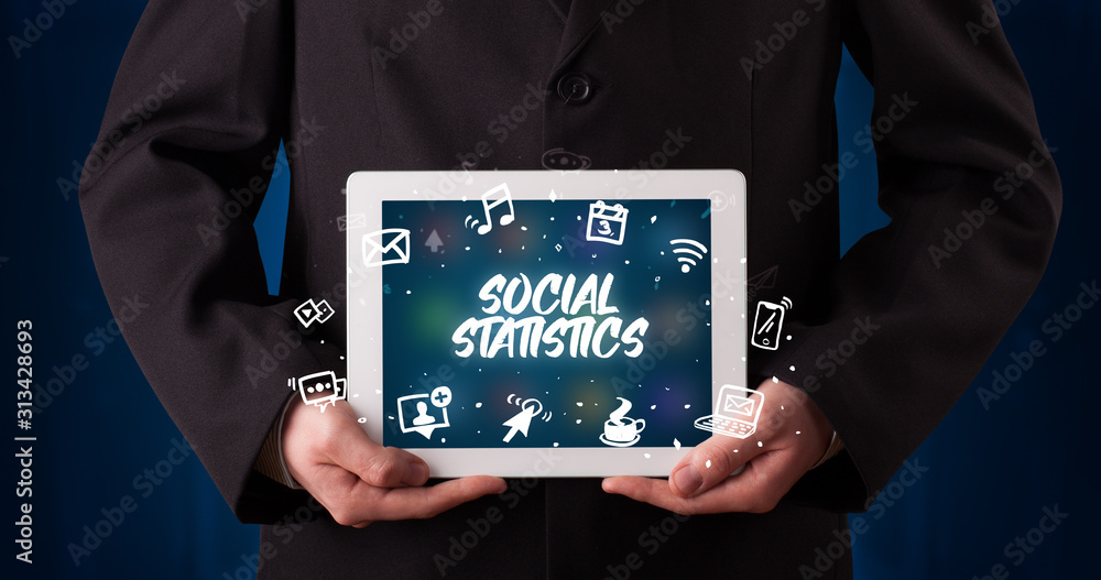 Young business person working on tablet and shows the inscription: SOCIAL STATISTICS Young business person working on tablet and shows the inscription: SOCIAL STATISTICS