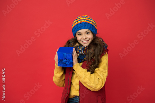 Online shop. childhood happiness. nice purchase. girl with new year present box. happy winter holidays. little girl knitted hat and scarf. merry christmas. xmas party mood. winter shopping sales