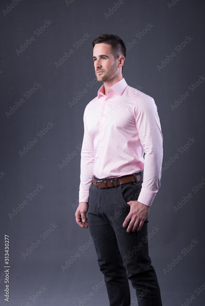 young man in a pink shirt and dress pants Stock Photo