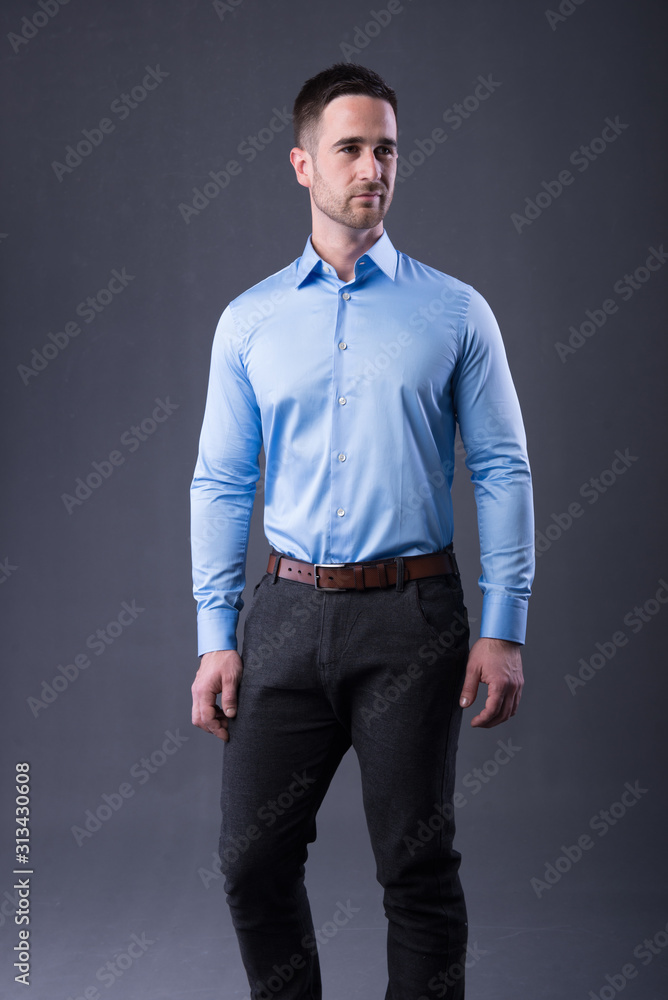 young man in a blu shirt and dress pants young man in a blu shirt and dress pants