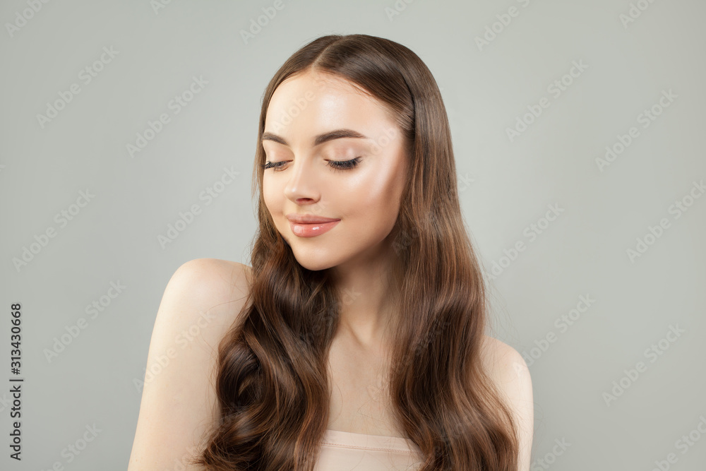 Beautiful young smiling woman with long brown hair smiling and perfect clear skin Beautiful young smiling woman with long brown hair smiling and perfect clear skin