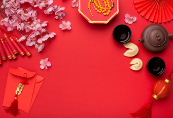 Chinese New Year flat lay red background with assorted festival decorations