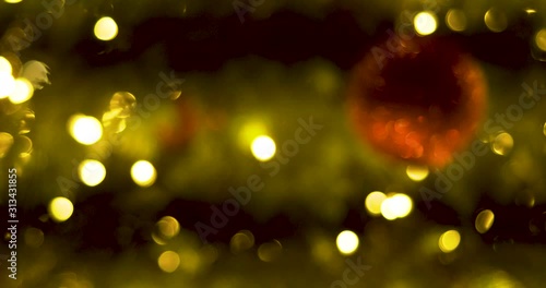 Defocused lights of the moving Christmas tree. Christmas background decoration