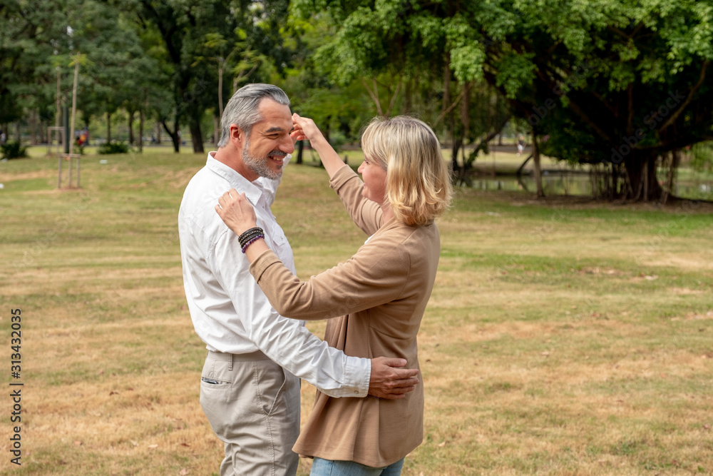 Fototapeta premium Portrait Caucasian elder couple are dancing in park. Happy elder couple concept