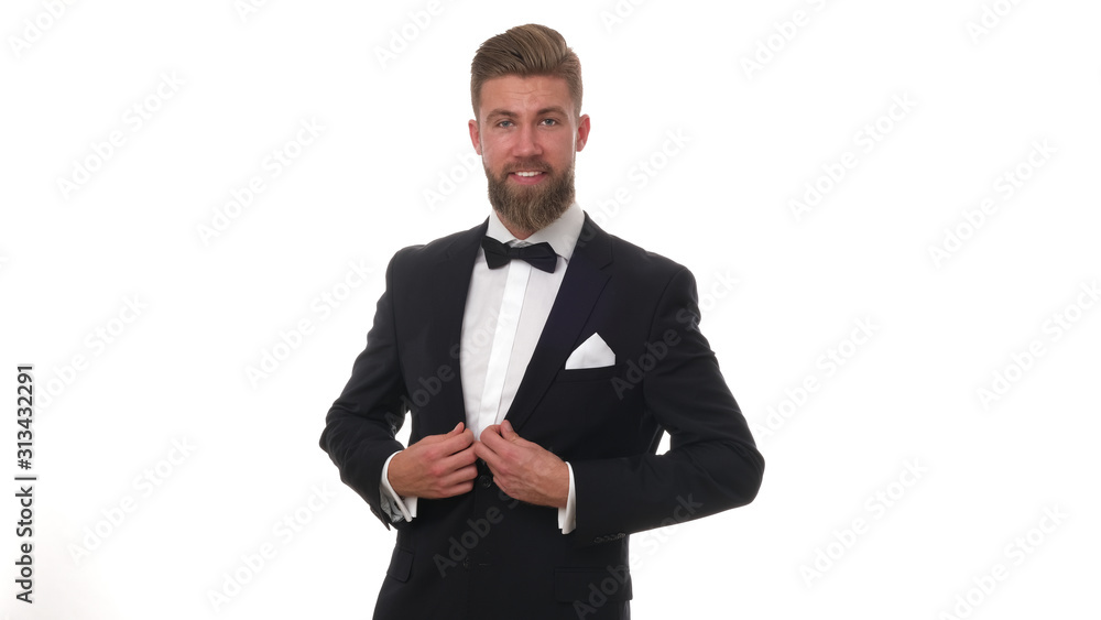 Good looking young man with beard wearing classic black suit, isolated on white background. Good looking young man with beard wearing classic black suit, isolated on white background.