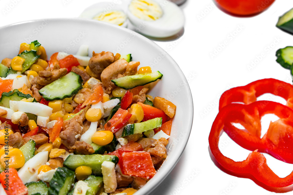 Bright vegetable salad in a white plate Isolated on a white background. Cooking a delicious dietary salad. Bright vegetable salad in a white plate Isolated on a white background. Cooking a delicious dietary salad.