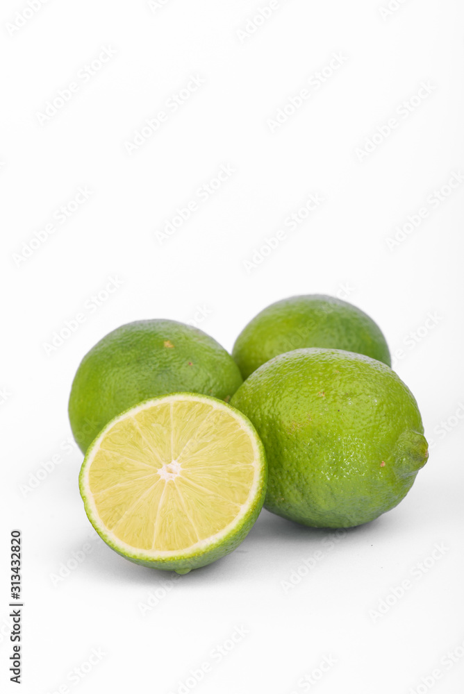 Fresh lime, half and quarter part on white background. Green citrus fruit. Fresh lime, half and quarter part on white background. Green citrus fruit.