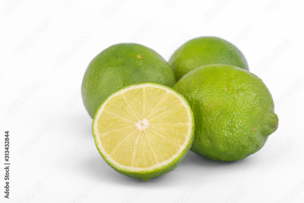 Fresh lime, half and quarter part on white background. Green citrus fruit. 