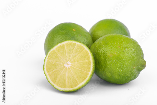 Fototapeta Naklejka Na Ścianę i Meble -  Fresh lime, half and quarter part on white background. Green citrus fruit. 