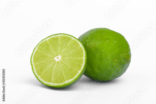 Fresh lime, half and quarter part on white background. Green citrus fruit. 