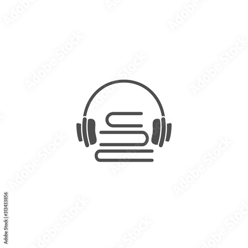black stack of books with headphones or headset isolated on white background.