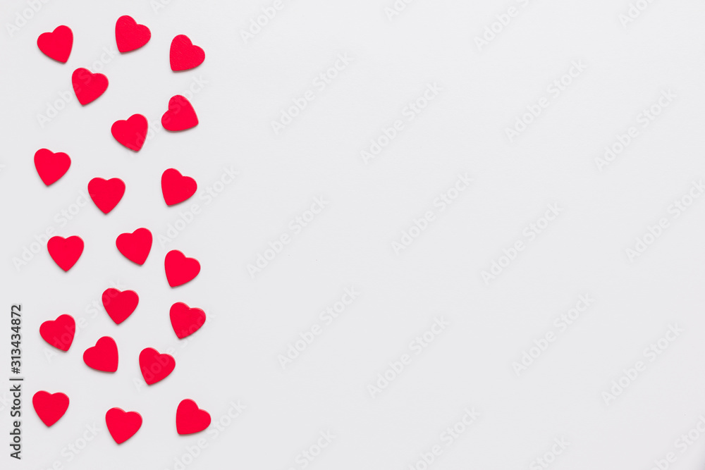 Stock photo of wooden red hearts on a white background with a space for text