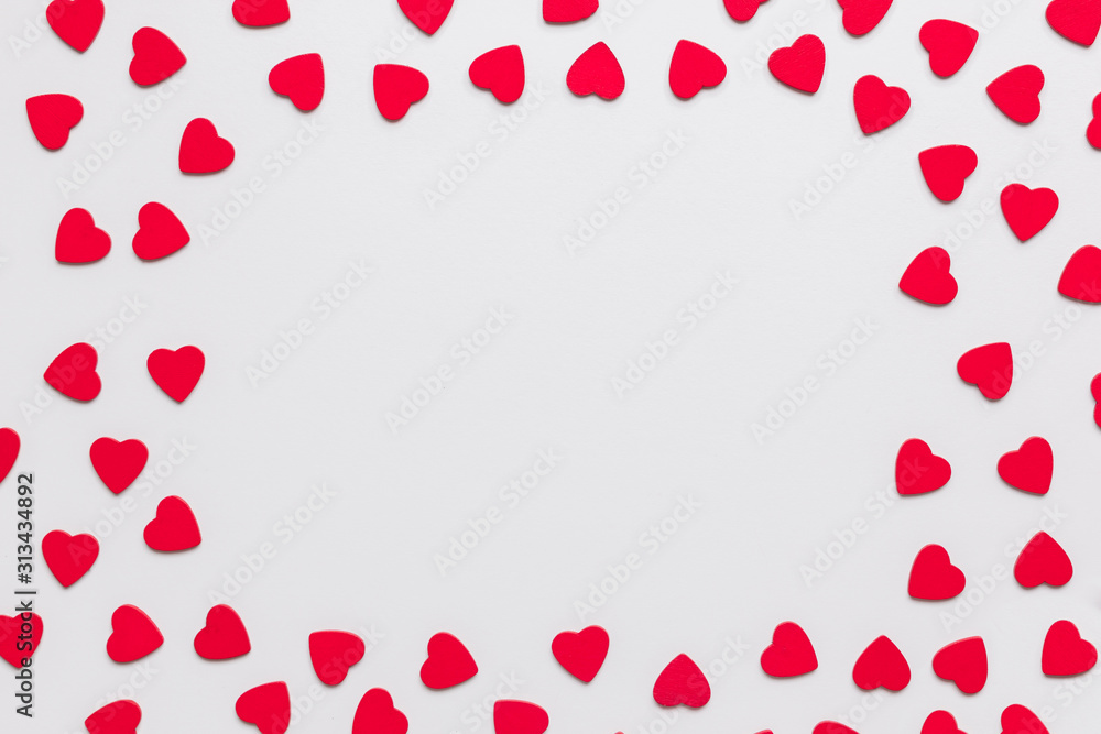 Stock photo of wooden red hearts on a white background with a framed space for text