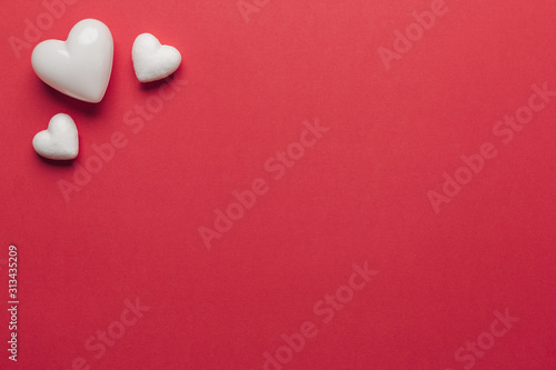 Stock photo of white hearts on a red background with space for text © AdriaVidal