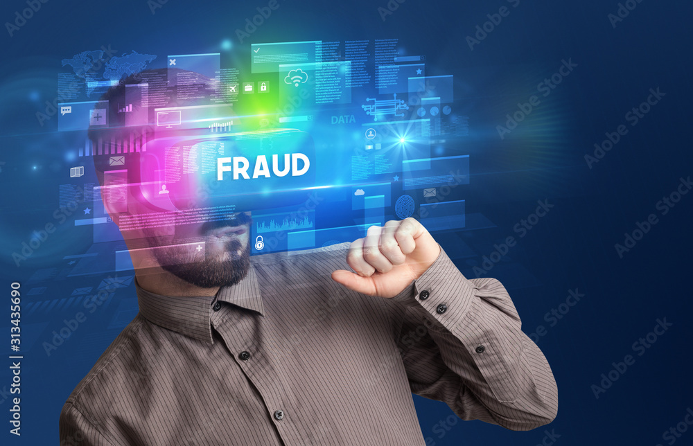 Businessman looking through Virtual Reality glasses with FRAUD inscription, innovative security concept Businessman looking through Virtual Reality glasses with FRAUD inscription, innovative security concept