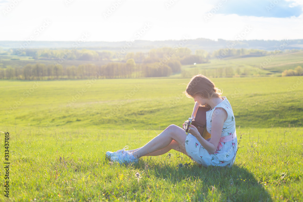 Beautiful young woman playing guitar at sunset Beautiful young woman playing guitar at sunset