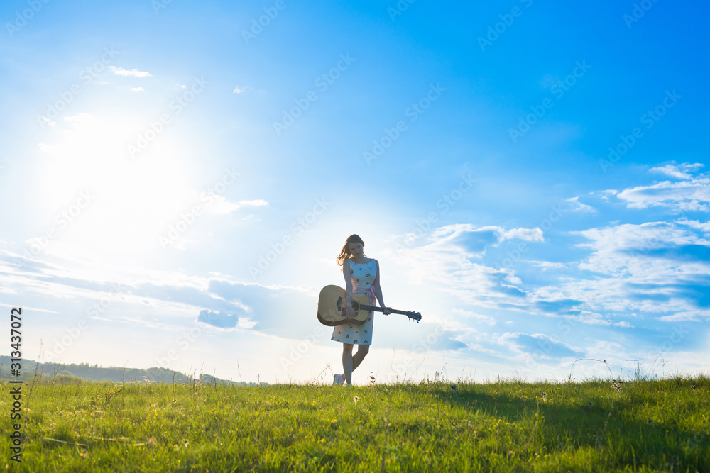 Women with guitar over sunset sky, Selective Focus. Women with guitar over sunset sky, Selective Focus.