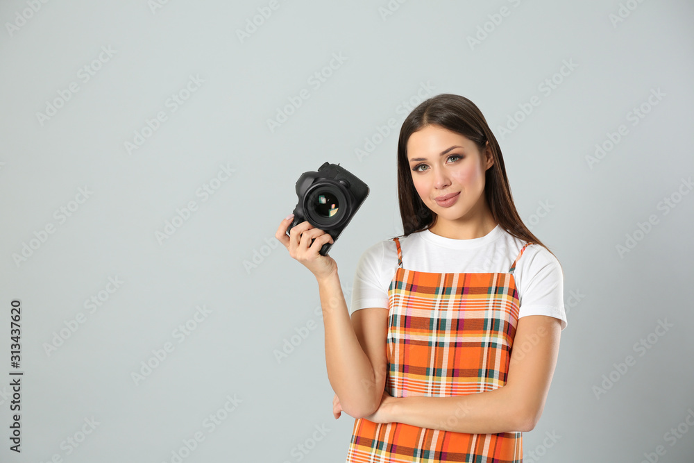 Fototapeta premium Professional photographer working on light grey background in studio. Space for text