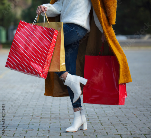 woman with shopping bags in hands