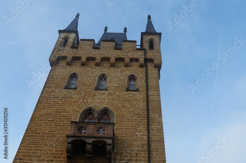 Hohenzollern Castle tower with a balcony and three windows. Photo taken from an upward perspective photo