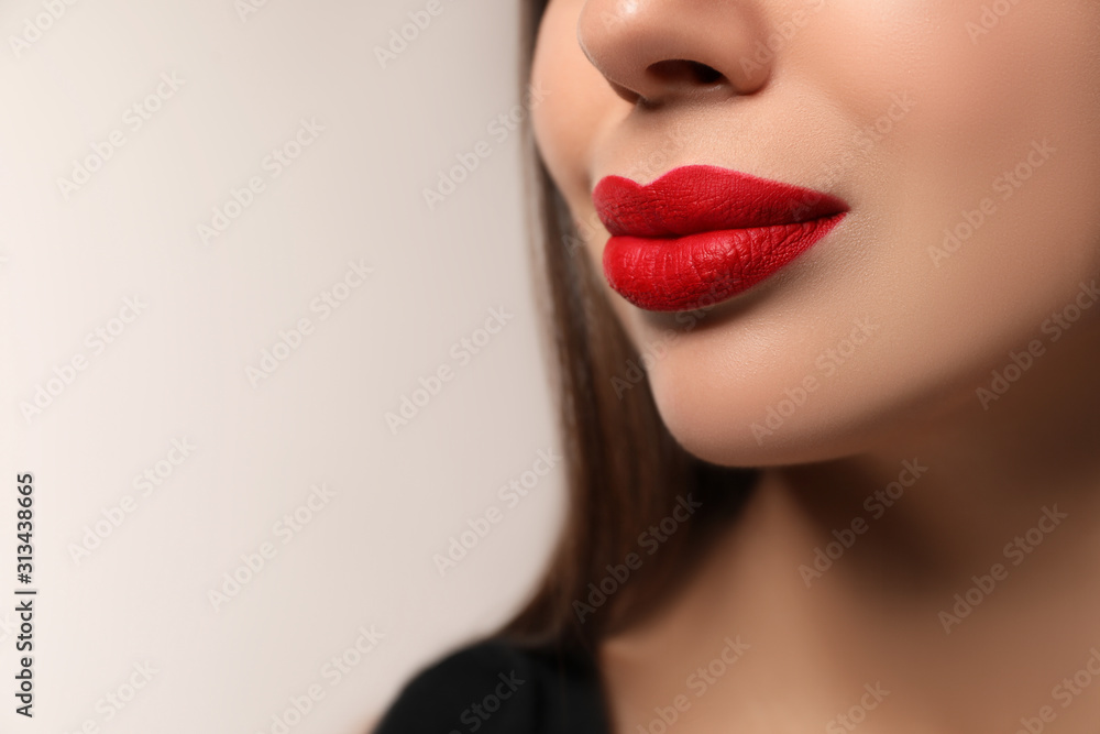 Beautiful woman with red lipstick on light background, closeup. Space for text Beautiful woman with red lipstick on light background, closeup. Space for text