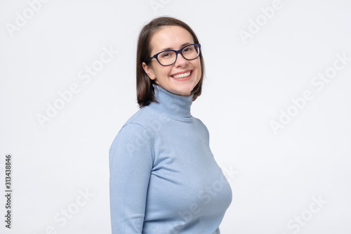 Attractive caucaisn mature woman in glasses smiling looking at camera. photo