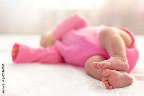 Cute little newborn sleeping. Focus on her feet