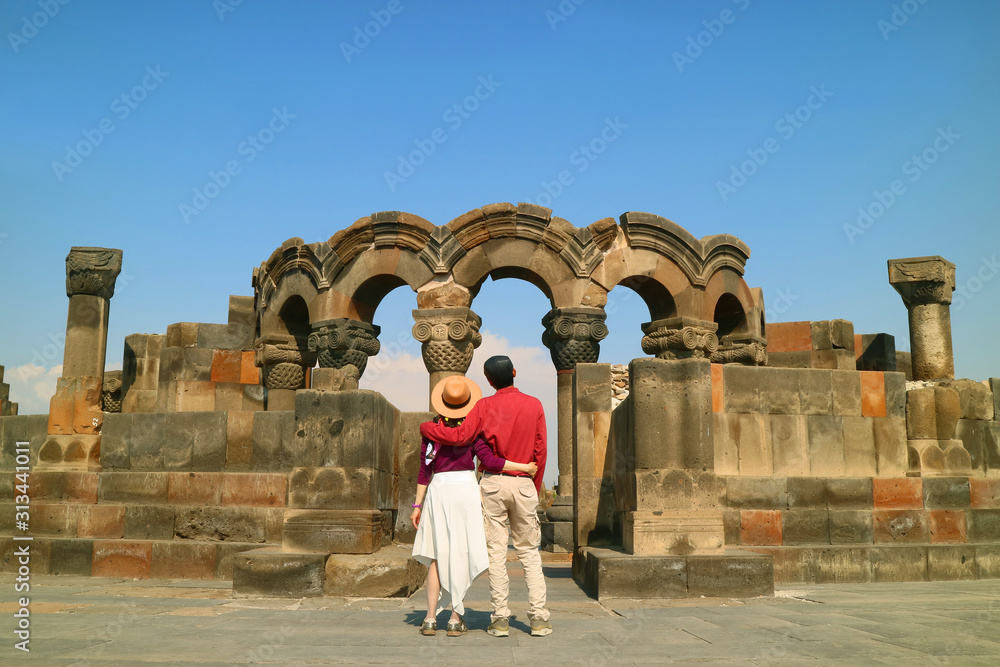 Couple Impressed by the Ancient Zvartnots Cathedral, the Famous Ruins in Armavir Province of Armenia