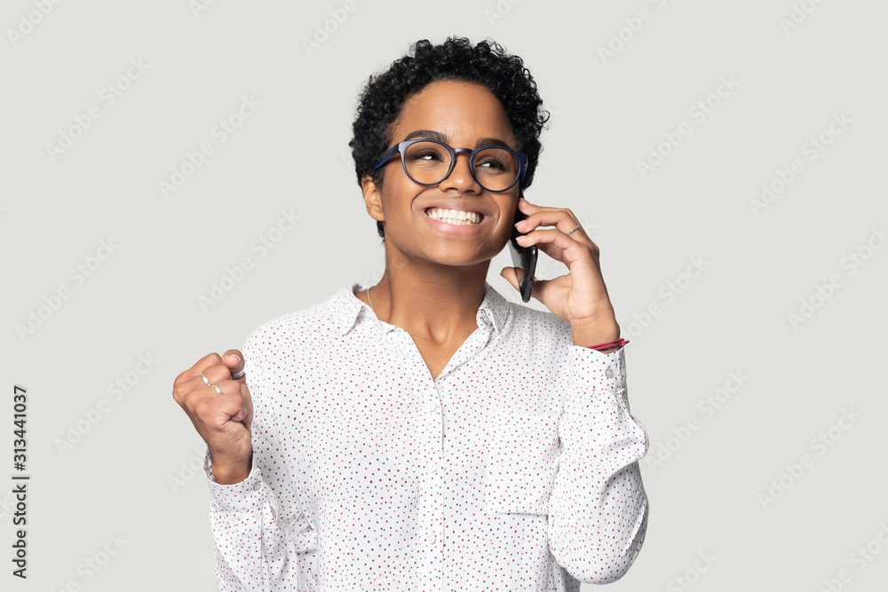 African woman talking on cellphone happy to hear good news African woman talking on cellphone happy to hear good news