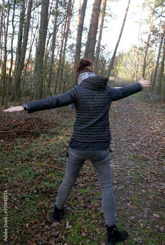 woman does physical exercises in the autumn forest