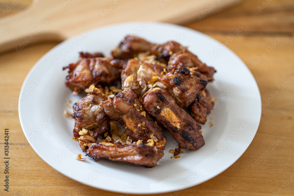 Fried ribs with garlic on white plate. Fried ribs with garlic on white plate.