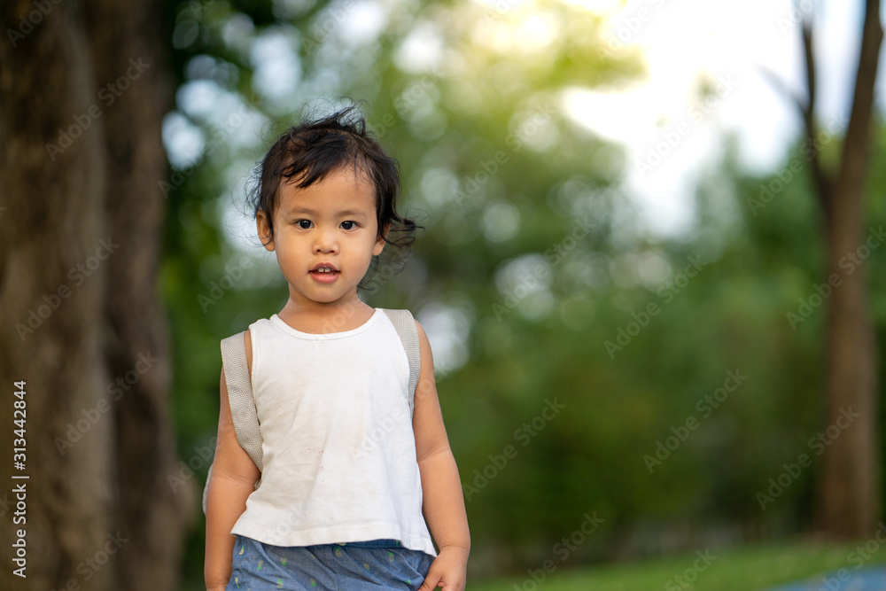 Cute little girl playing at park during sunset hour. Cute little girl playing at park during sunset hour.