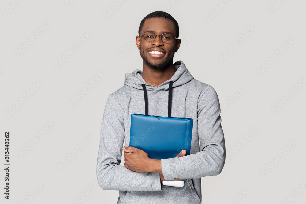 African student holding in hands folder studio shot African student holding in hands folder studio shot