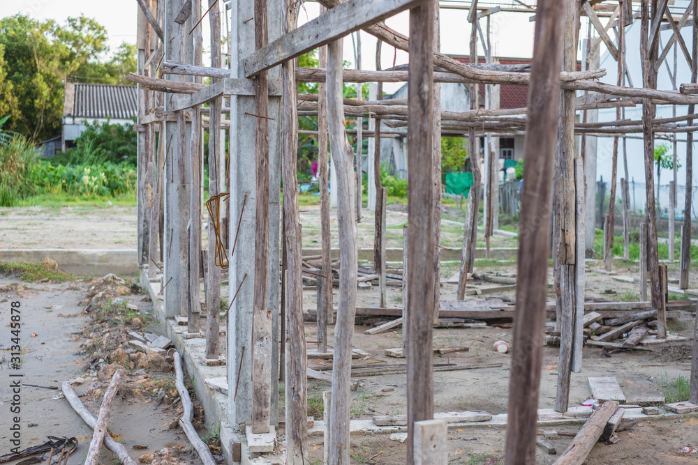 Temporary wooden scaffolding structure in a new house building used to support labours and material in the construction or repair of buildings Temporary wooden scaffolding structure in a new house building used to support labours and material in the construction or repair of buildings