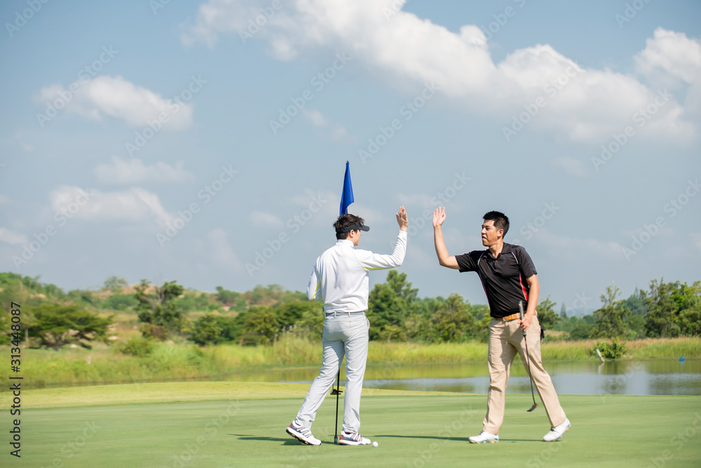 Two Asian man golfer  high  five at golf course