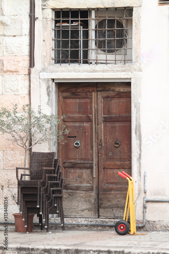 Front door, brown front dual doors with a nice stone staircase with black hand railing