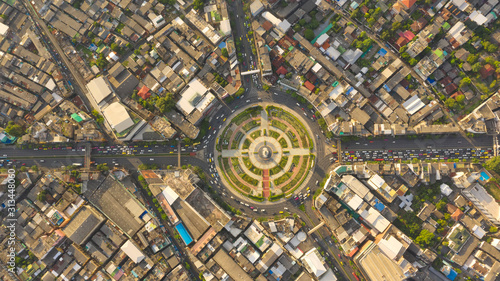 Road roundabout with car lots Wongwian Yai in Bangkok,Thailand. street large beautiful downtown at evening light. Aerial view , Top view ,cityscape ,Rush hour traffic jam.