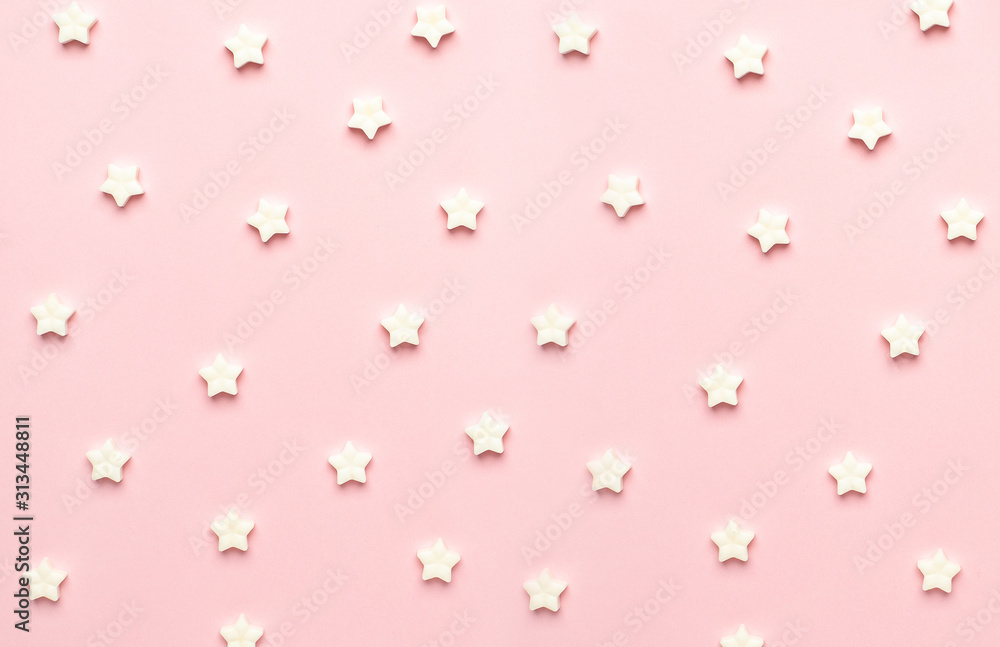 White sweet star lollipops on a pink background macro view White sweet star lollipops on a pink background macro view