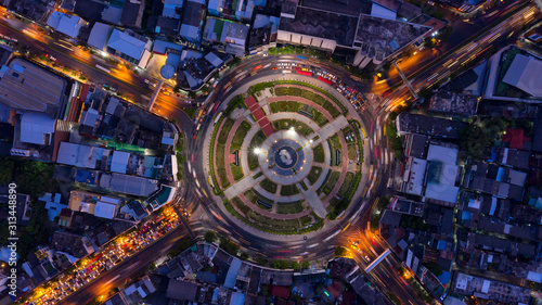 Road roundabout with car lots in Bangkok Thailand. street large beautiful downtown at evening light.  Aerial view   Top view  cityscape  Rush hour traffic jam.