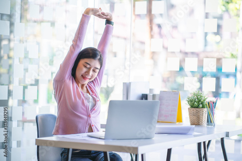 Wallpaper Mural Asain young business woman stretching her arms to relax after finish working. Torontodigital.ca