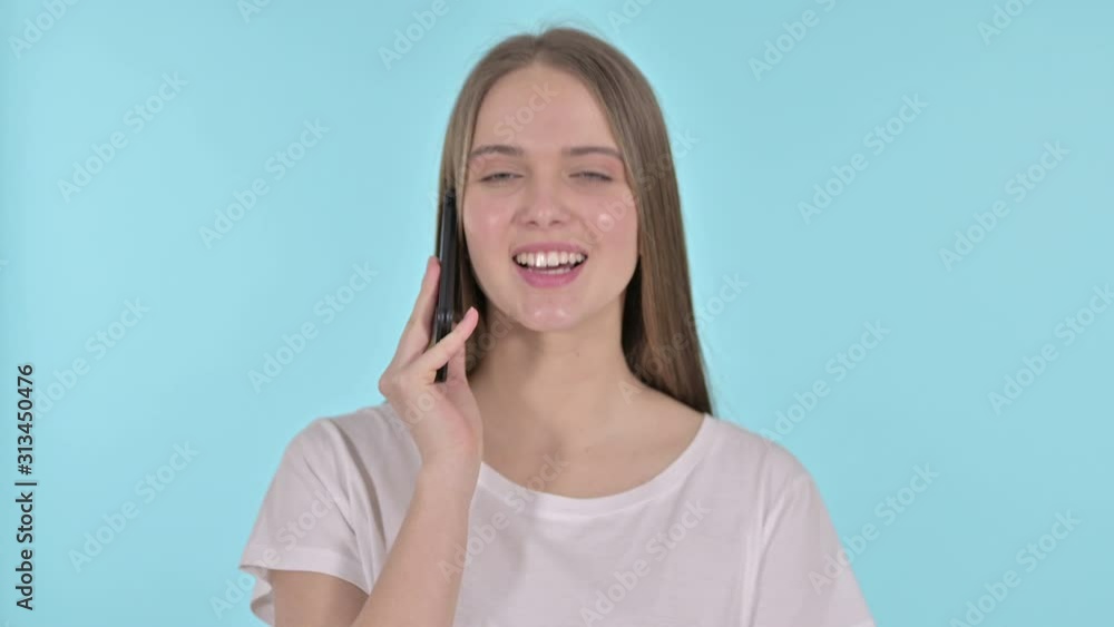 Beautiful Young Woman Talking on Smartphone , Blue Background Beautiful Young Woman Talking on Smartphone , Blue Background
