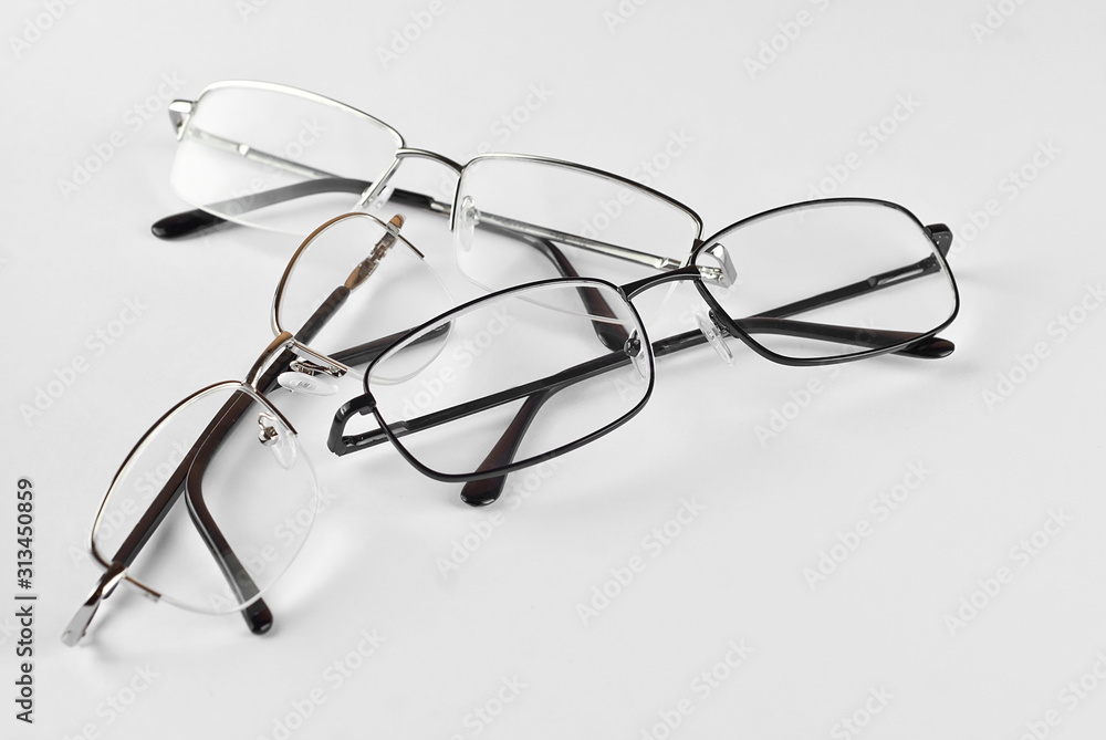 Glasses on a white background. Rectangular glasses in different frames. Three pairs of glasses. Glasses on a white background. Rectangular glasses in different frames. Three pairs of glasses.